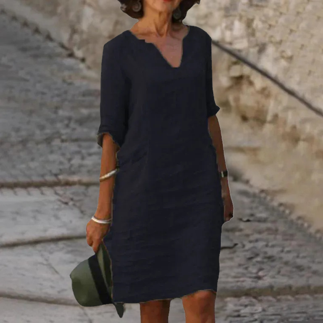 "Abito elegante donna scollo a V, tessuto morbido, silhouette valorizzata, ideale per cerimonie e occasioni speciali."