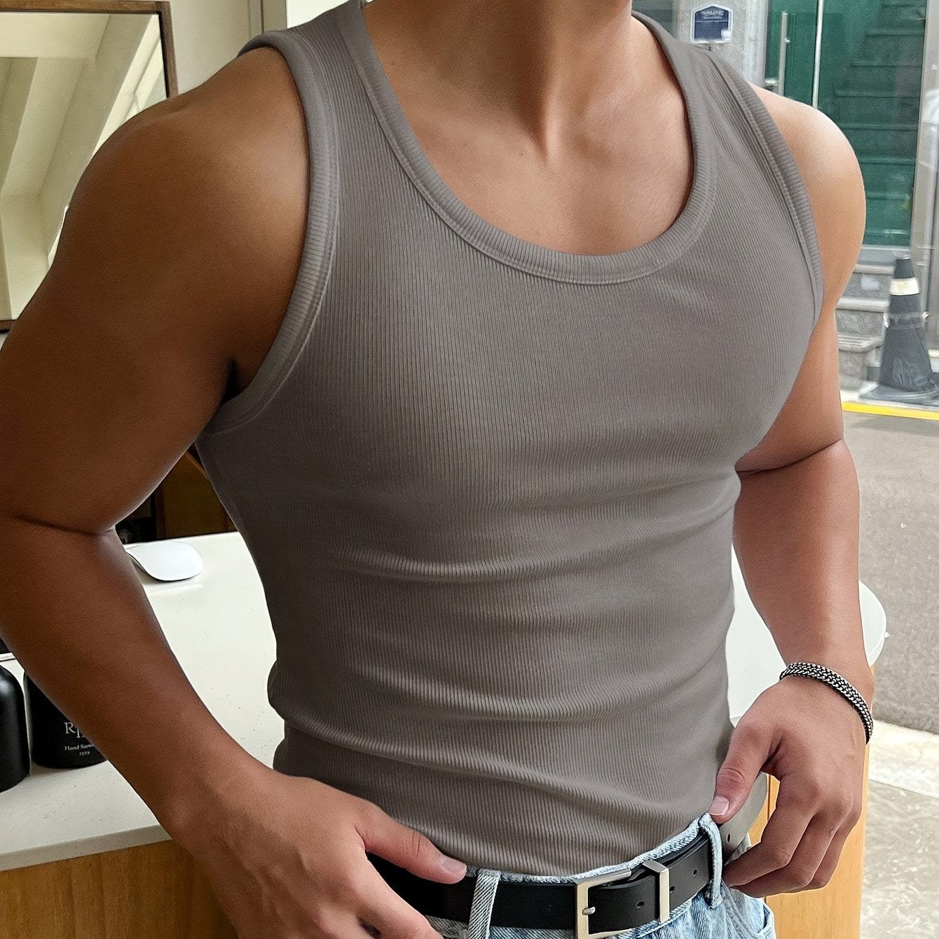 "Canotta uomo estiva traspirante, colore neutro, design minimalista slim fit per look casual e sportivo, vista frontale."