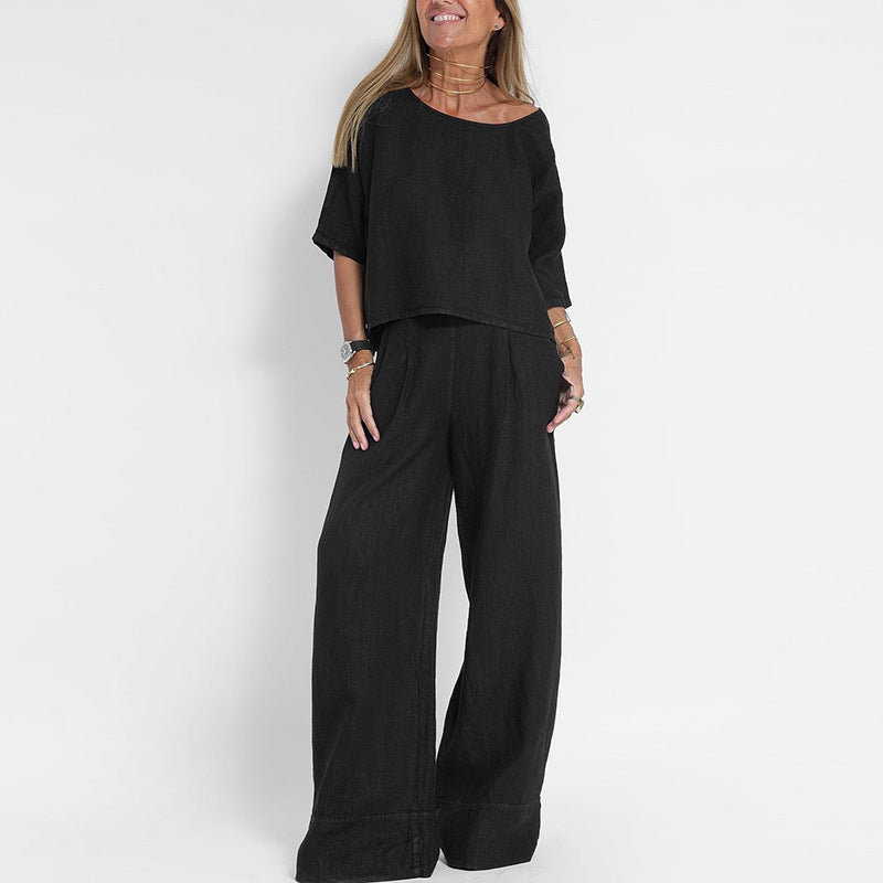 "Completo estivo lino donna, top manica corta e pantaloni ampi in tessuto leggero, eleganza casual per giornate soleggiate."