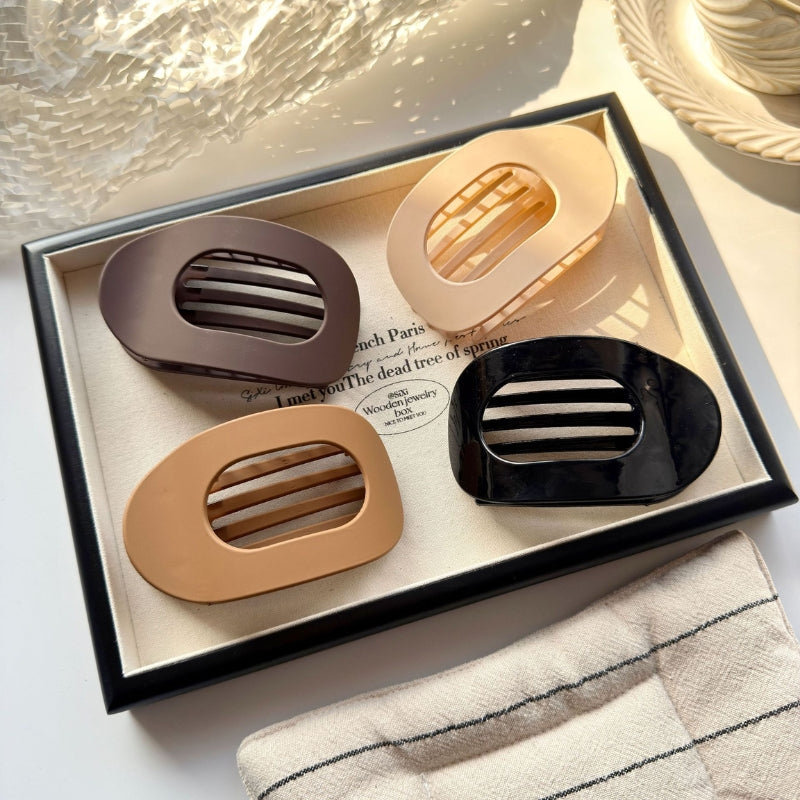 Women's minimalist claw clips, 4-pack, offer strong hold for all hair types. Perfect hair accessory for styling.