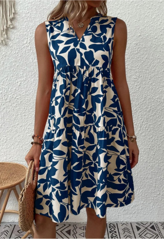 Abito estivo donna A-linea senza maniche con stampa floreale vivace, tessuto leggero e scollo rotondo elegante.