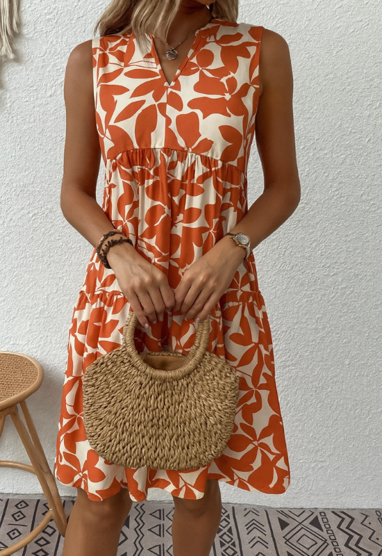 Abito estivo donna A-linea senza maniche con stampa floreale vivace, tessuto leggero e scollo rotondo elegante.