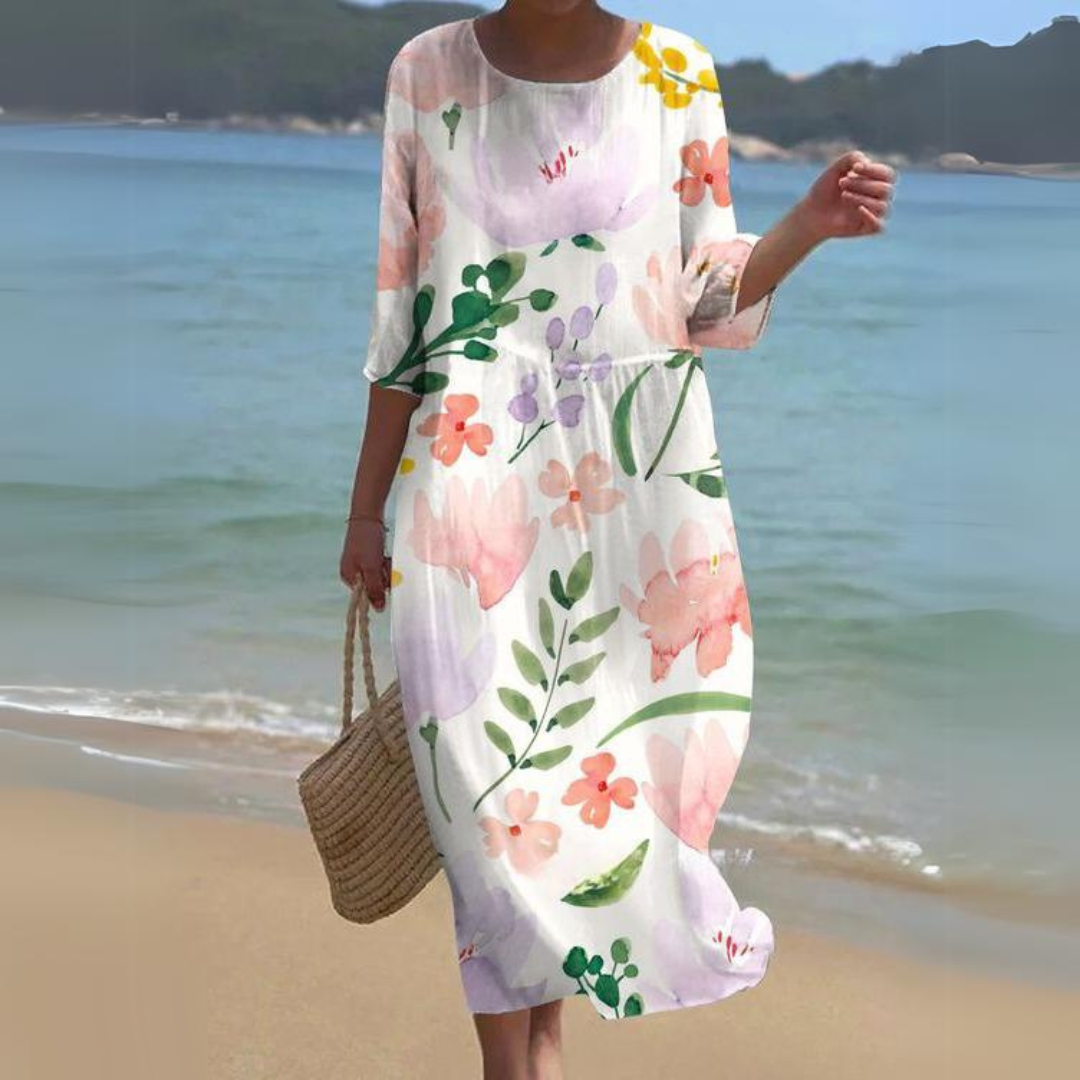 "Abito estivo floreale da donna elegante con stampa floreale delicata, in cotone leggero e vestibilità lusinghiera."