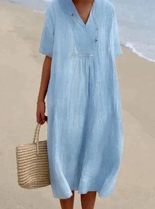"Abito estivo in lino con scollo a V e maniche corte, perfetto per look casual ed eleganti. Disponibile in colori versatili."