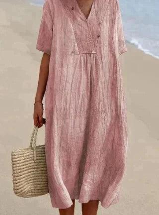 "Abito estivo in lino con scollo a V e maniche corte, perfetto per look casual ed eleganti. Disponibile in colori versatili."