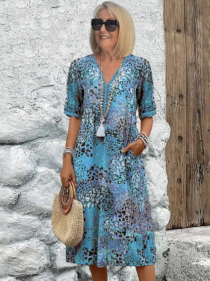 "Abito midi da donna con scollo a V, tessuto leggero e colori multipli. Elegante e versatile per ogni occasione."