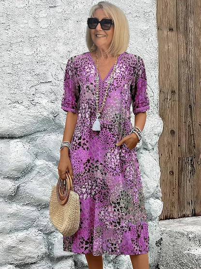 "Abito midi da donna con scollo a V, tessuto leggero e colori multipli. Elegante e versatile per ogni occasione."