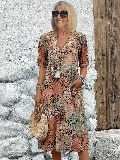 "Abito midi da donna con scollo a V, tessuto leggero e colori multipli. Elegante e versatile per ogni occasione."