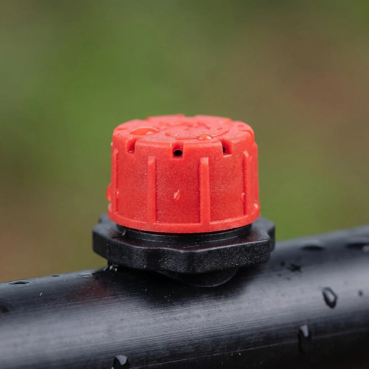 Micro drip irrigation drippers with adjustable flow for tailored watering of garden plants & pots.