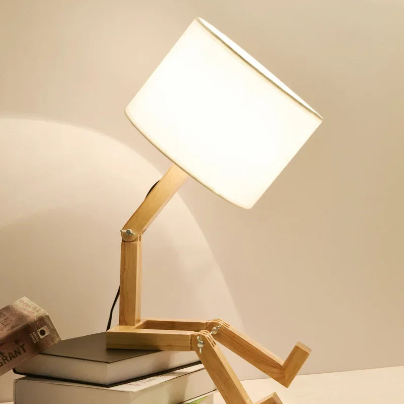 Versatile wooden robot desk lamp, fully adjustable for task lighting or a cozy atmosphere.
