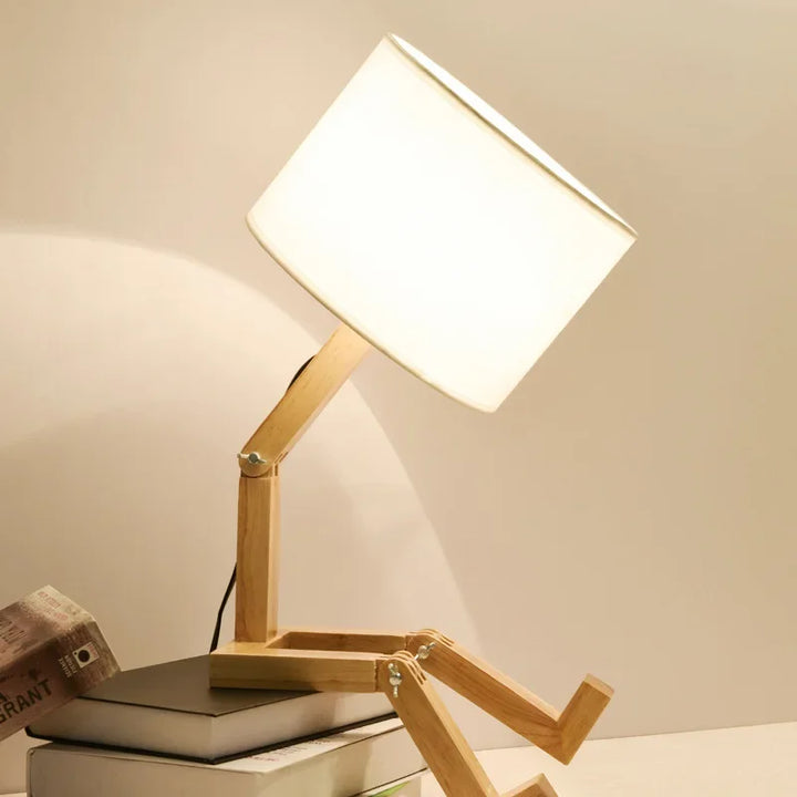 Versatile wooden robot desk lamp, fully adjustable for task lighting or a cozy atmosphere.