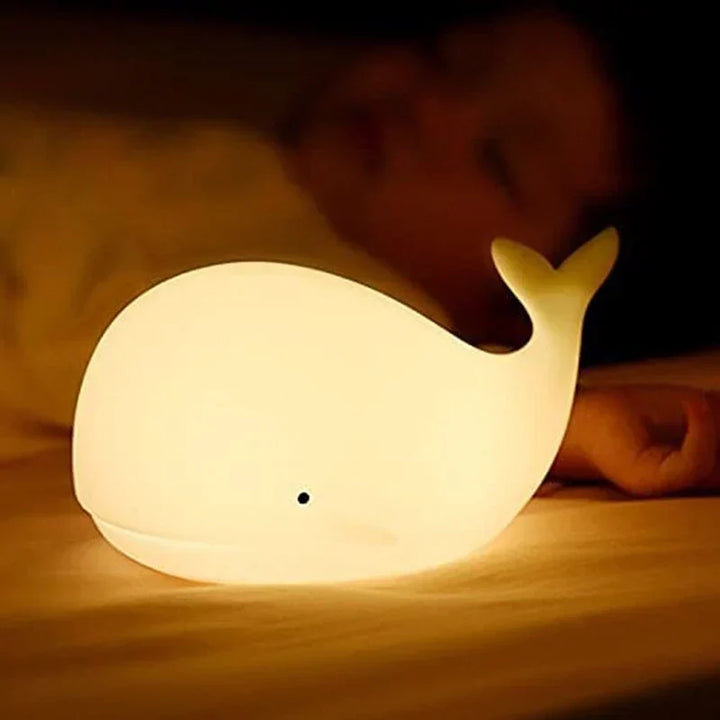 Soothing color-changing whale night light calms kids, perfect for nursery. Safe silicone, easy touch control LED.