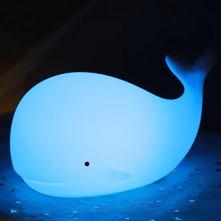 Adorable silicone whale night light with color-changing LED glow, a comforting nursery lamp for children.