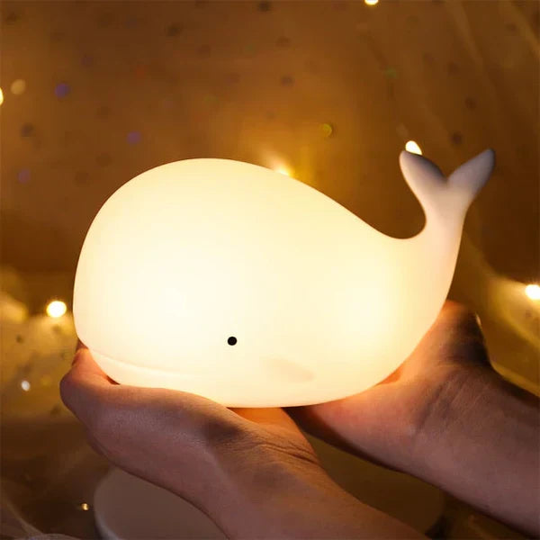 Kids' whale night light, color-changing LED, soft silicone, touch control. Soothing glow for nursery decor.