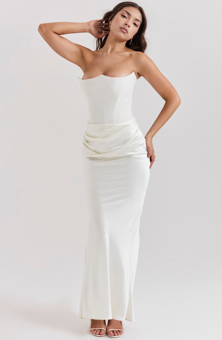 Long pink wedding guest dress, a formal strapless maxi design.