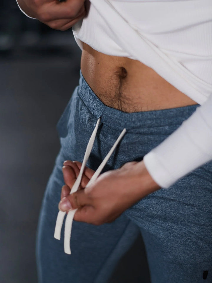 Navy blue men's athletic joggers, front view, highlighting elastic waistband.