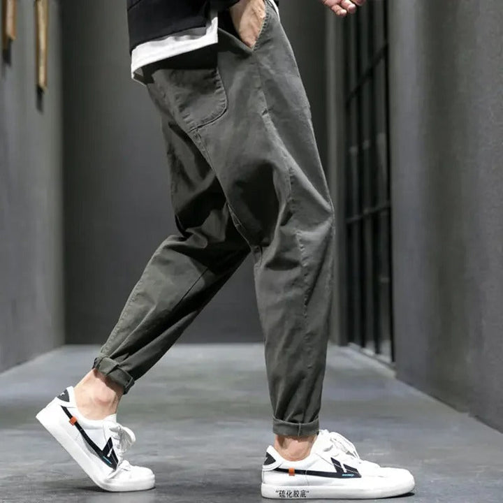 Detail shot of comfortable men's tapered joggers fabric, showcasing quality & relaxed fit.