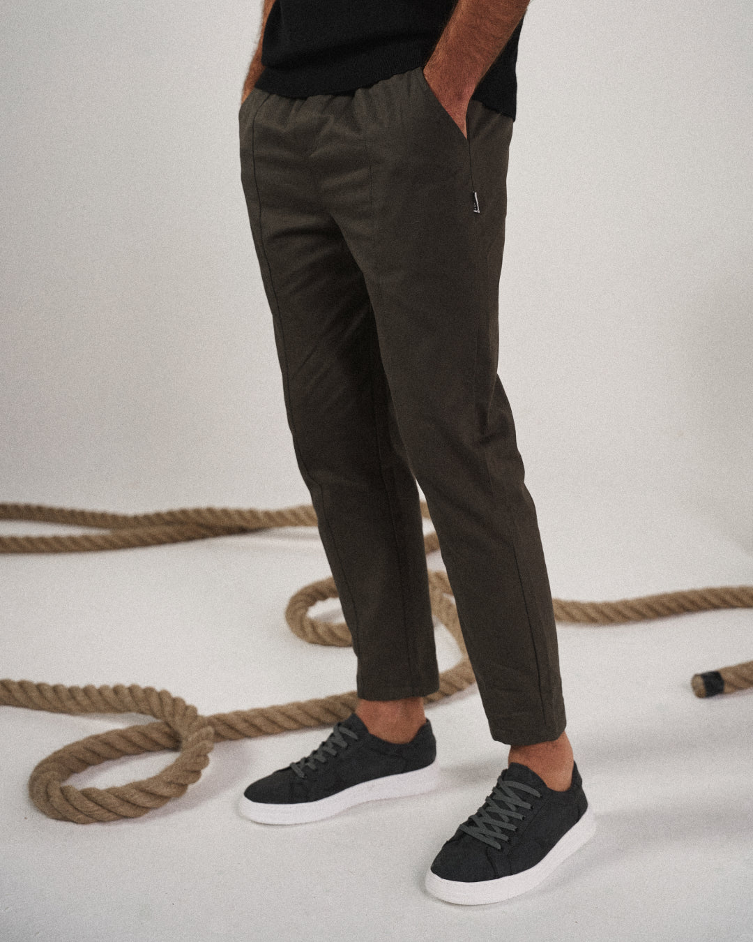 Man in relaxed pose wearing comfortable men's tapered joggers, suitable for active or leisure days.