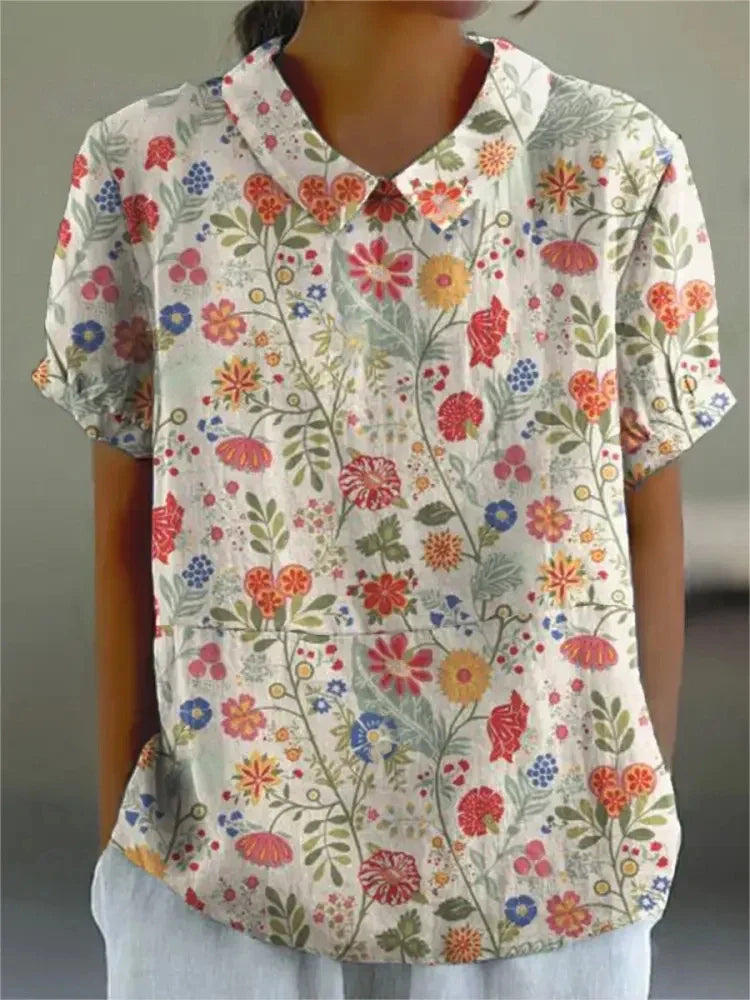 "Blusa floreale elegante in cotone e lino, colori vivaci, design versatile, vestibilità comoda per donna"