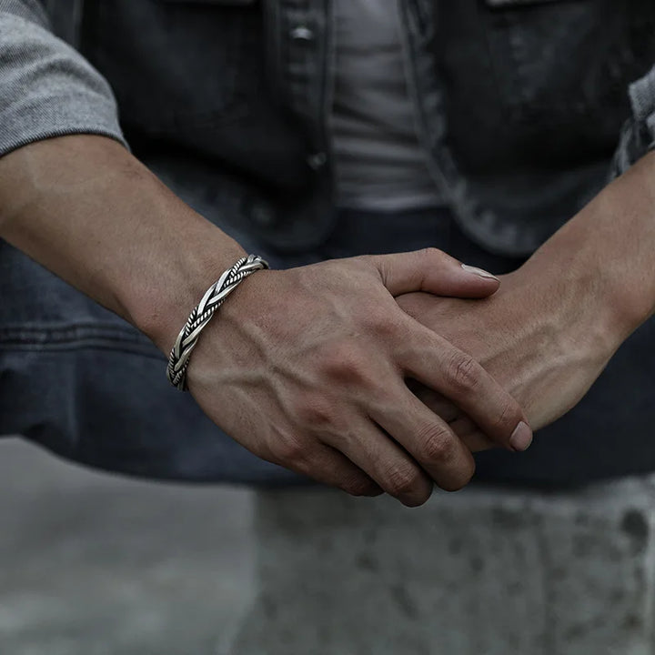 Modern men's sterling silver cuff bracelet with a unique twisted design, high-quality jewelry.