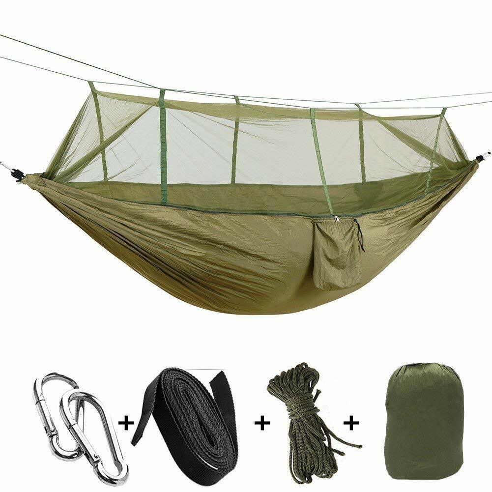 Insulated camping hammock setup with an underquilt, mosquito net, and rainfly for cold weather.
