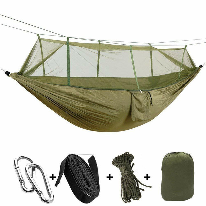 Insulated camping hammock setup with an underquilt, mosquito net, and rainfly for cold weather.