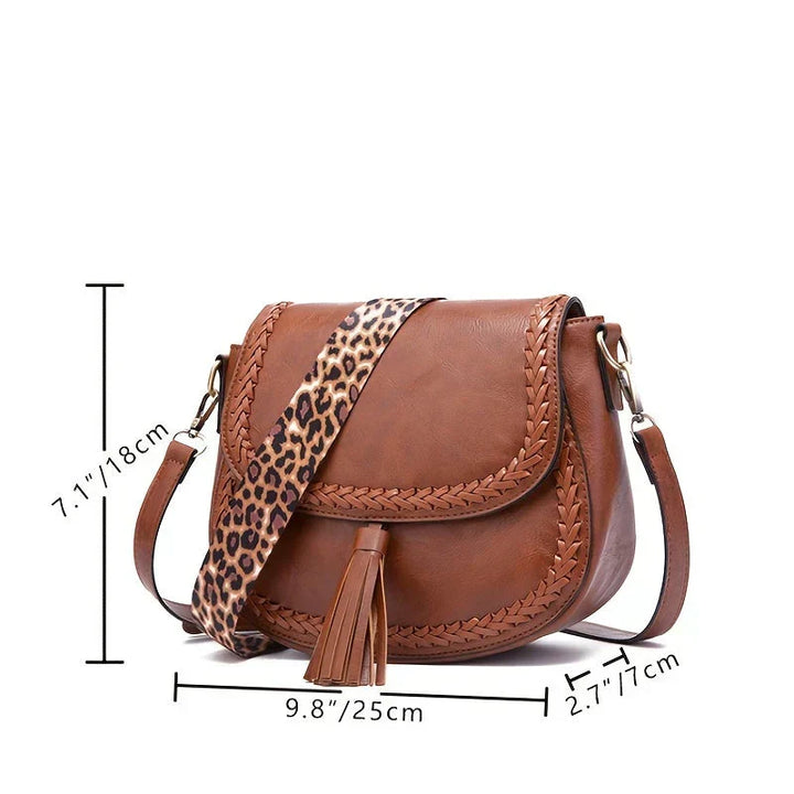 Clean white women's saddle bag, featuring a subtle tassel detail. Elegant and versatile.