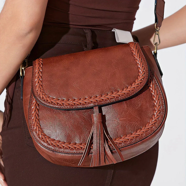 Elegant women's saddle bag in brown with tassel detail. A chic and versatile shoulder bag.