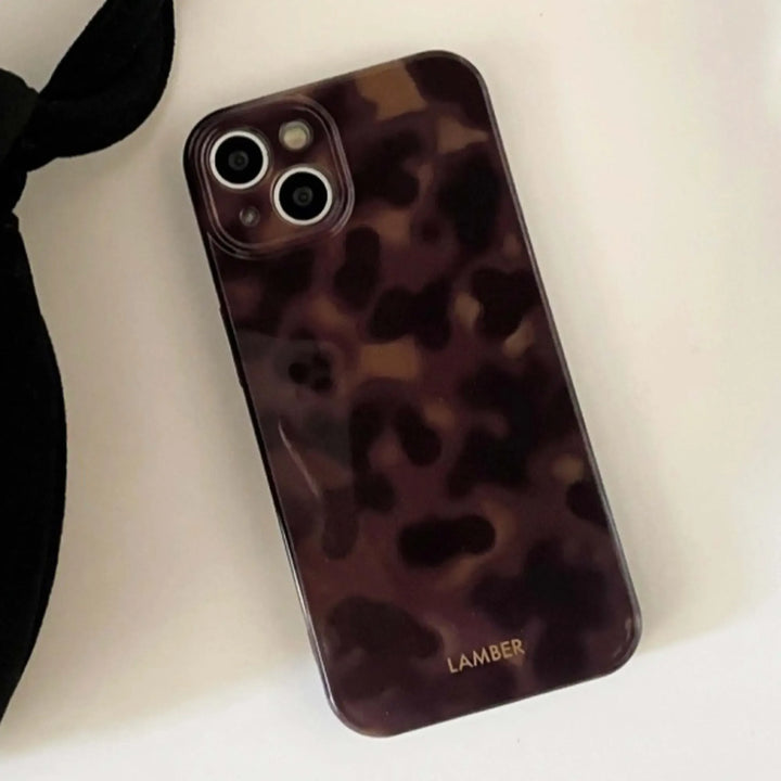 Elegant tortoiseshell design glass iPhone case with TPU bumper, a chic & protective fashion accessory.