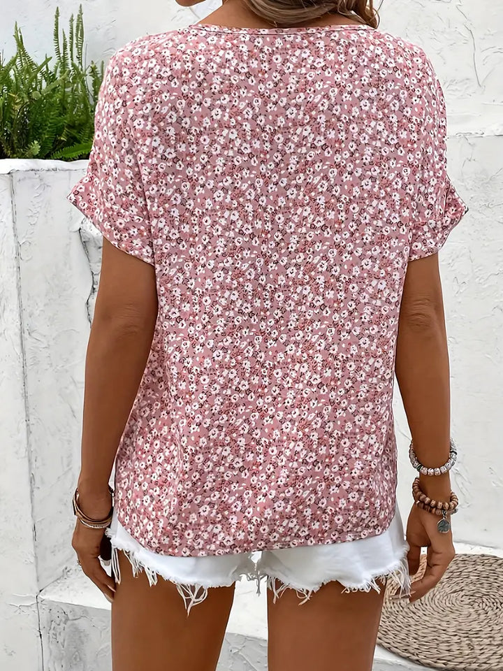 Detailed view of a women's effortless floral blouse, showcasing the vibrant print & delicate button-up front.
