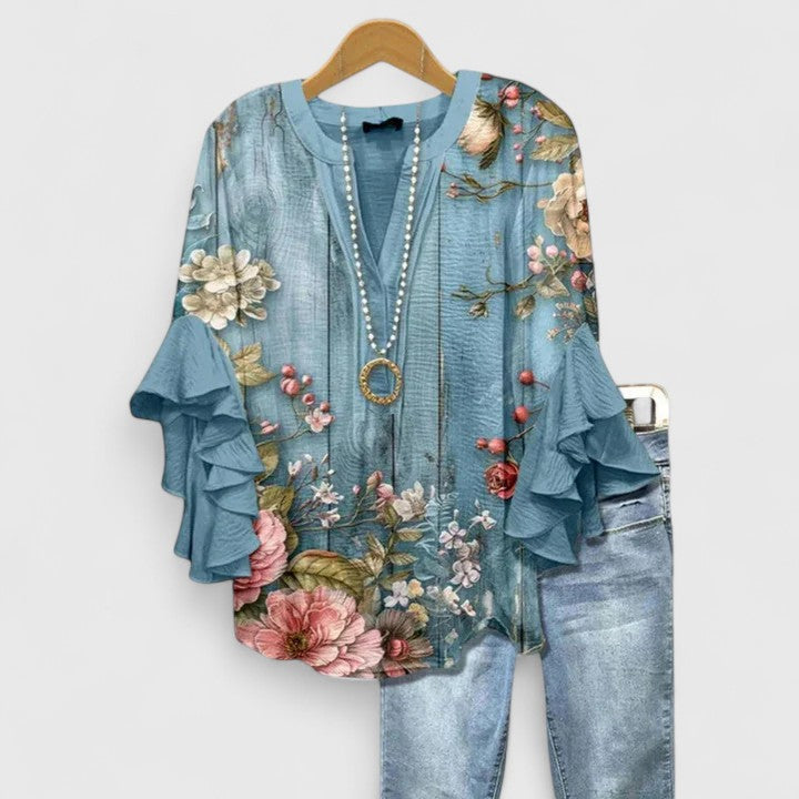 Casual yet elegant women's floral top with ruffled sleeves, perfect for a refined summer look.