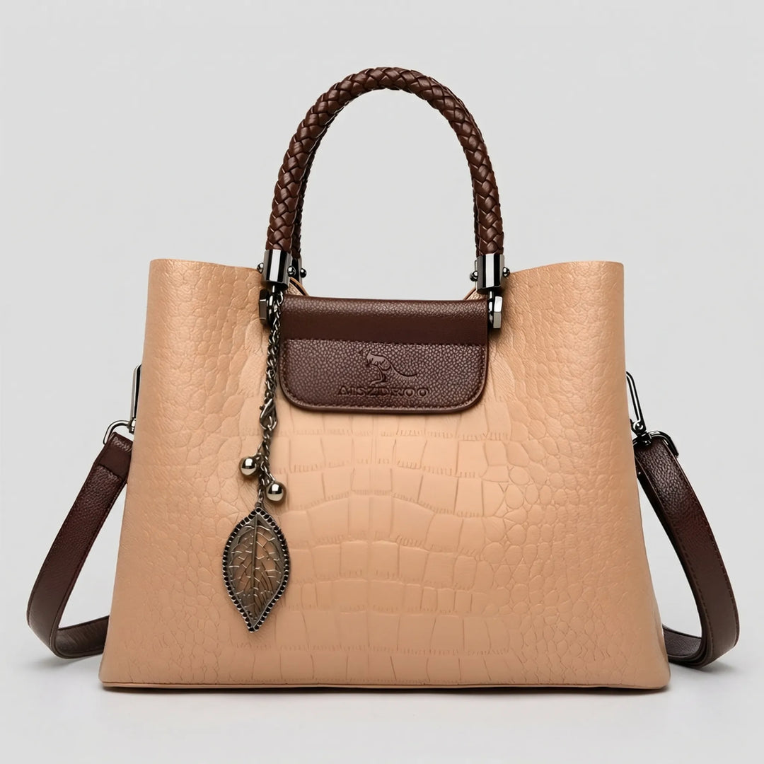 Stylish women's black embossed tote bag, perfect for daily use. Features a unique braided handle & elegant design.