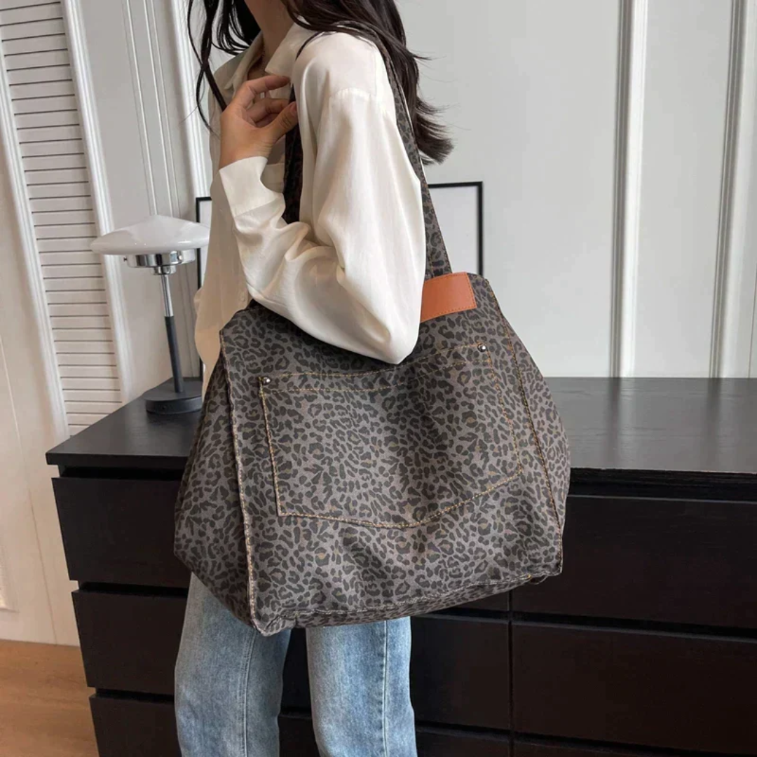 Bold leopard print handbag, a striking women's fashion accessory and chic everyday tote bag.