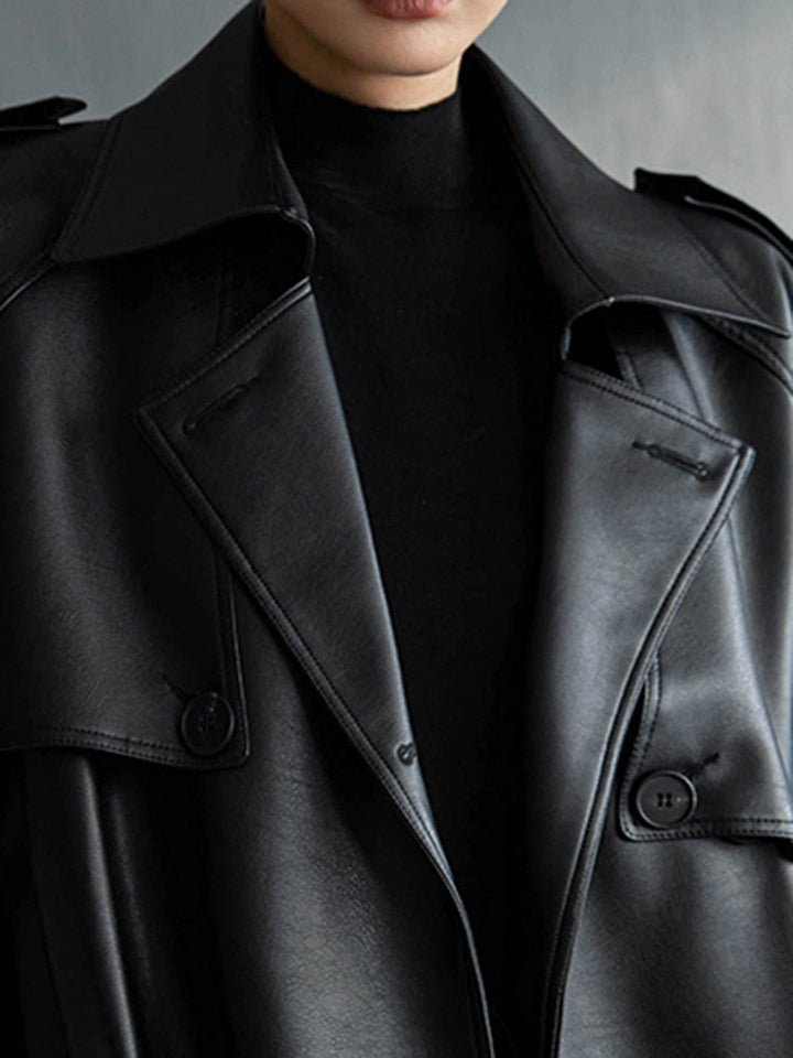 Full length view of a women's chic long trench coat, adding elegance to any spring outfit.