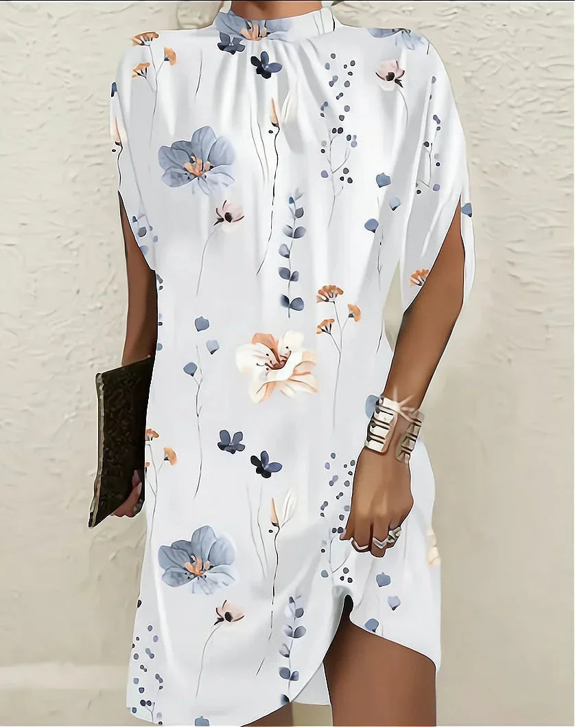 Stylish women's spring fashion mini dress, featuring a mock neck and sophisticated cape sleeves.