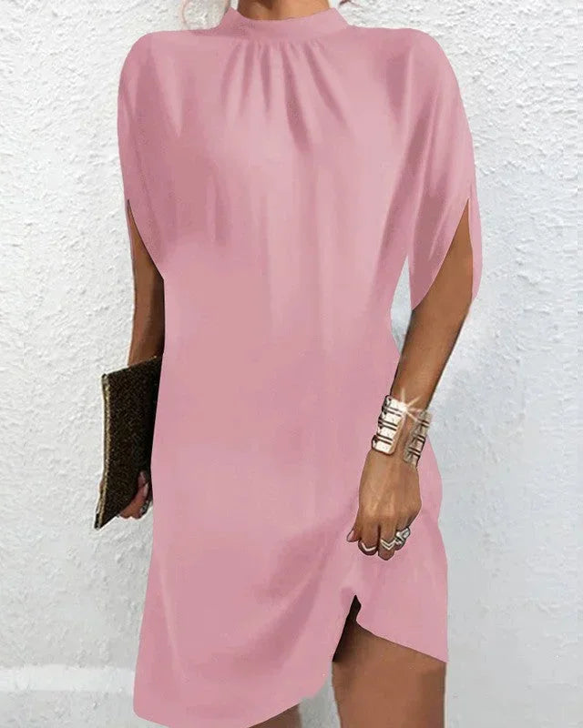 Modern women's mock neck mini dress with chic cape sleeves & an asymmetric hem, a stylish choice.