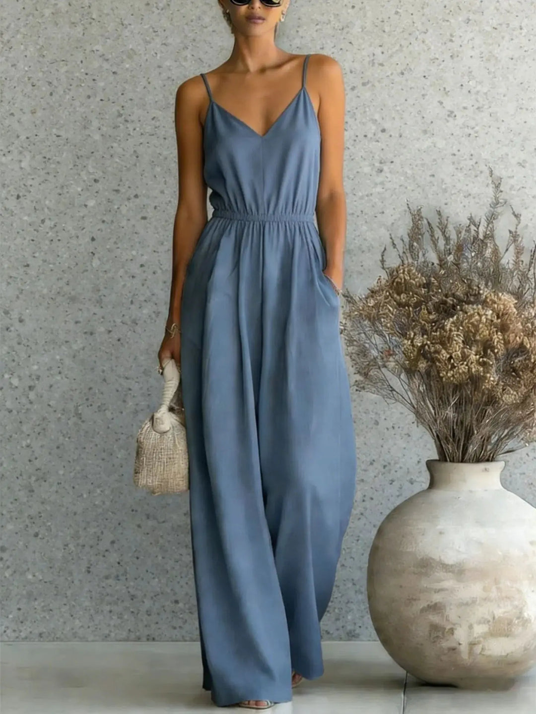 Stylish women's V-neck wide leg casual jumpsuit, perfect for summer. This chic, relaxed fit one-piece is vacation ready.