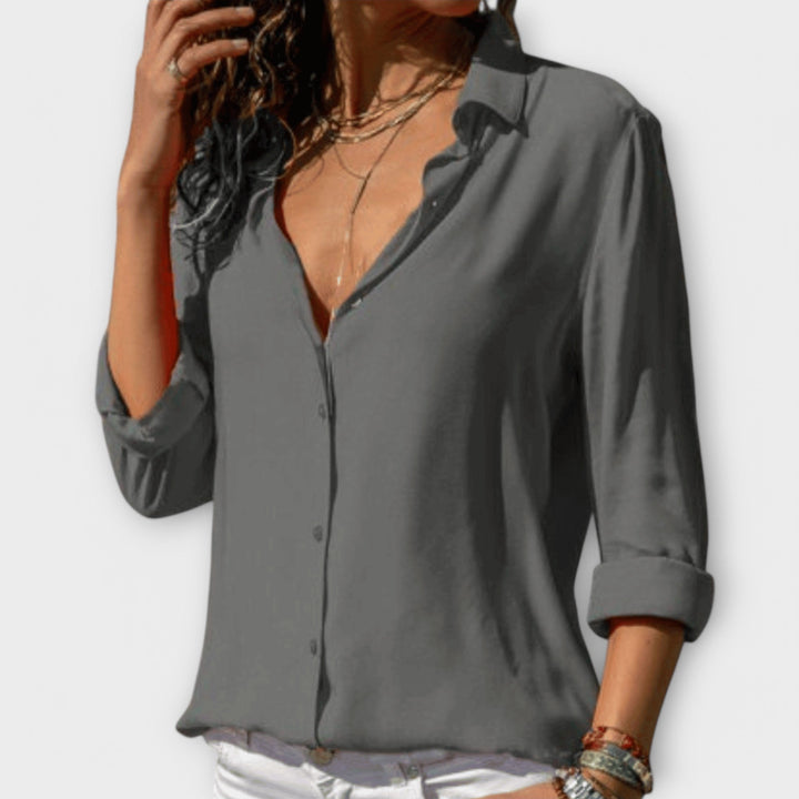 Stylish black women's blouse with long sleeves, ideal for evening elegance & chic office attire.