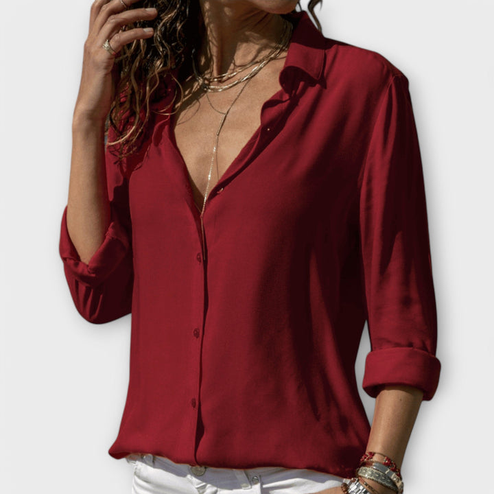Professional women's long-sleeve office blouse in a vibrant color, offering comfort & style.