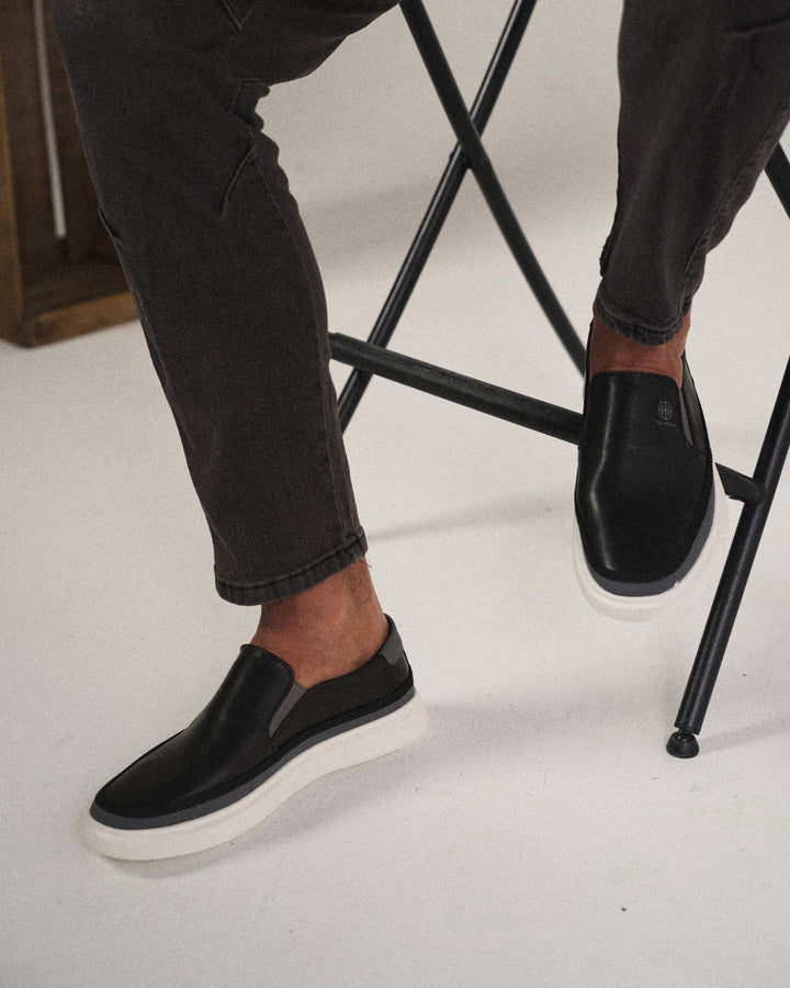 Stylish men's white leather slip-on shoes, offering classic comfort and a sleek casual look.