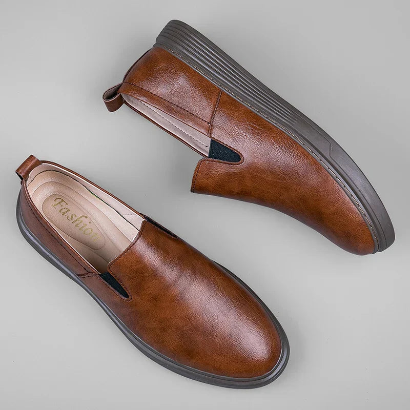 Comfortable black men's slip-on loafers, ideal dress shoes for business or casual outfits. Classic footwear.