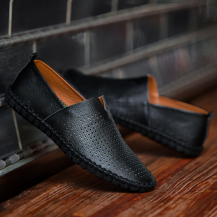 Detail of the hand-stitched craftsmanship on men's perforated casual slip-on loafers.