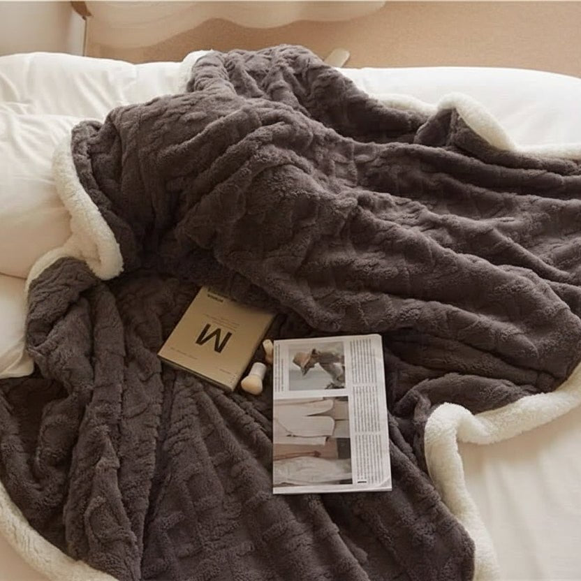 Reversible lambswool and microfiber flannel blanket, offering versatile soft comfort and warm luxury for bed or sofa.