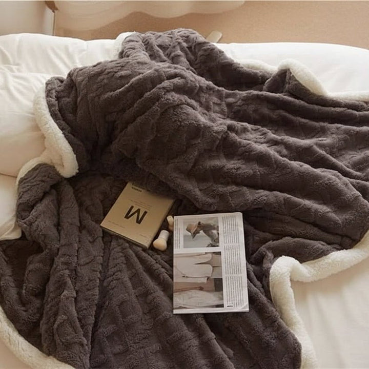 Reversible lambswool and microfiber flannel blanket, offering versatile soft comfort and warm luxury for bed or sofa.