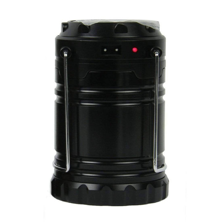 Portable LED lantern, collapsed with top handle, showing solar panel, practical camping gear.