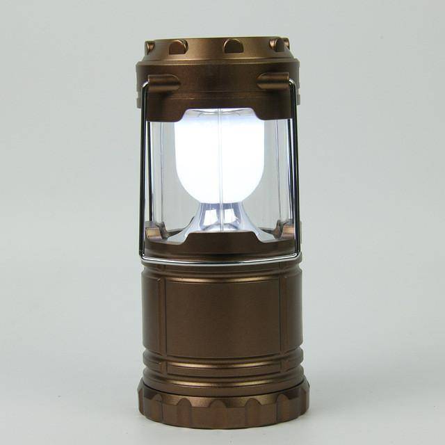 Rechargeable LED flashlight and lantern combo, in use outdoors, versatile survival equipment.
