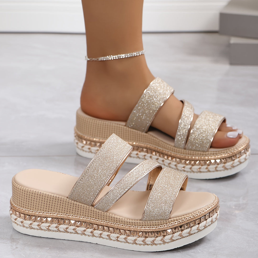 Stylish beige flat slip-on sandals for women, featuring soft straps for comfortable casual summer wear.