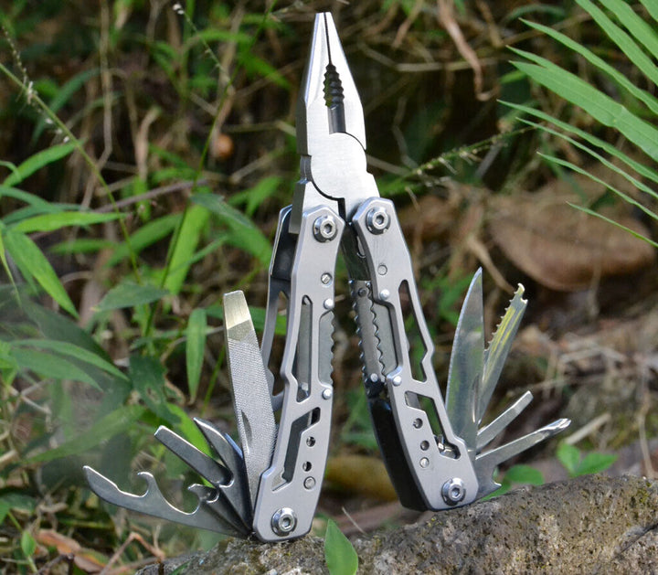 Multitool showing various tools: knife, saw, bottle opener, for camping/hiking