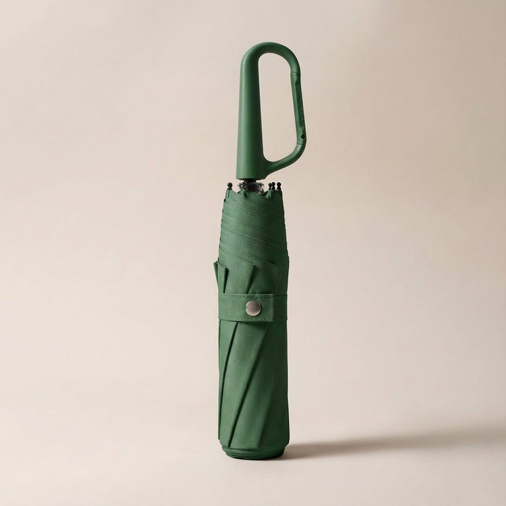 Clip-on foldable umbrella, closed and ready for travel, highlighting its small size and easy carry.