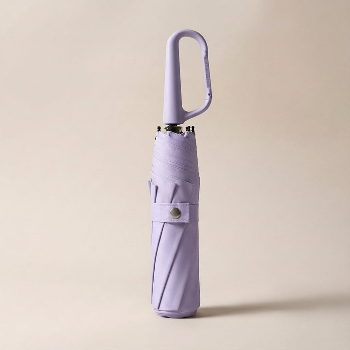 Compact umbrella unfolded, showcasing its wide coverage and reliable waterproof, UV-blocking fabric.